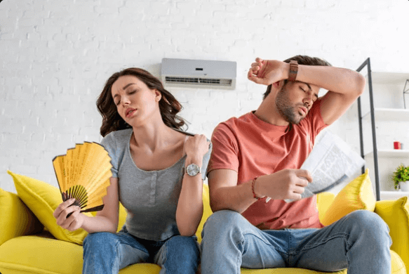 an image displaying the homeowners struggling due to air conditioner blowing hot air