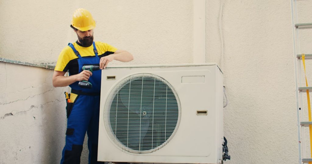 an image displaying a serviceman repairing the HVAC system